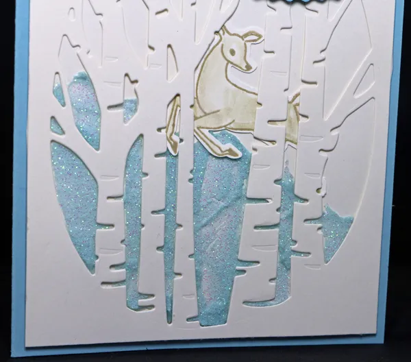 A detailed view of a stamped and punched deer on a charming winter scene on a Christmas card that shows how to make two cards from one design. A detailed view of a stamped and punched deer on a charming winter scene on a Christmas card that shows how to make two cards from one design.