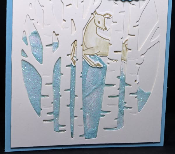 A detailed view of a stamped and punched deer on a charming winter scene on a Christmas card that shows how to make two cards from one design. A detailed view of a stamped and punched deer on a charming winter scene on a Christmas card that shows how to make two cards from one design.